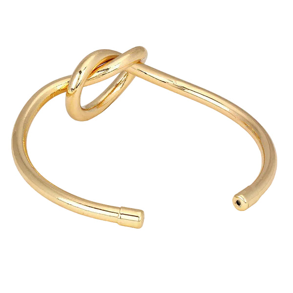 Gold bangle with a unique design on a light gray background