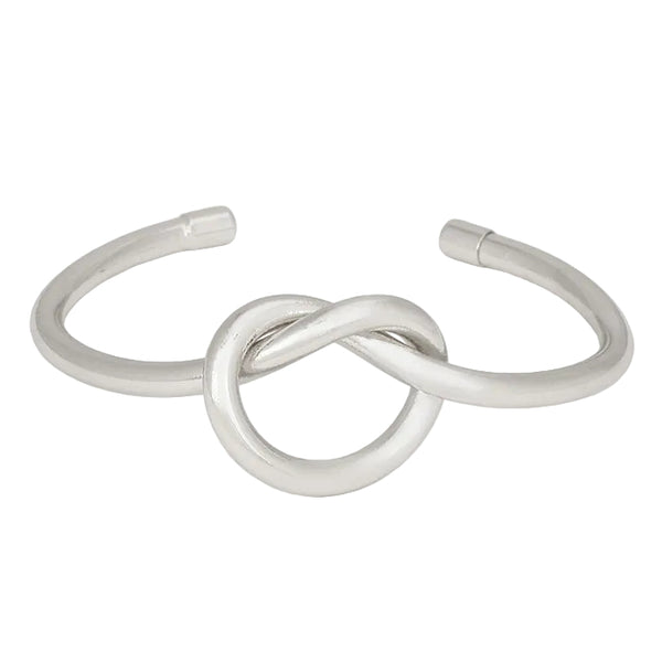 Silver bracelet with a knot design on a white background
