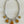 Load image into Gallery viewer, Necklace with yellow and silver circular pendants on a dark surface
