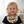 Load image into Gallery viewer, Child wearing a black shirt with a tiger patterned bib, smiling in a bright room.
