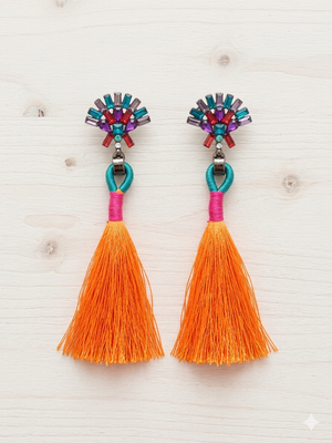Colorful tassel earrings with decorative elements on a light background