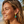 Load image into Gallery viewer, Woman on a beach wearing earrings with turquoise and green gemstones.
