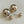 Charger l'image dans la galerie, Pair of gold spherical earrings on a light gray background
