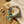Load image into Gallery viewer, Bracelet with turquoise and gold beads on a sandy surface
