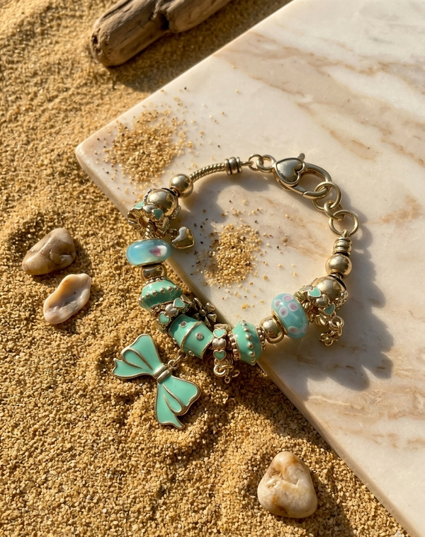 Bracelet with turquoise and gold beads on a sandy surface