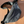 Load image into Gallery viewer, Black waist bag on a beige surface with a visible brand tag.
