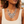 Load image into Gallery viewer, A close-up of a woman wearing a chunky silver statement necklace with circular and teardrop crystal details, paired with a cream ribbed tank top.
