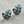 Charger l'image dans la galerie, Pair of decorative earrings with blue and silver design on a light gray background
