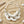 Charger l'image dans la galerie, A statement necklace featuring large white mother-of-pearl disc pendants, layered with silver beaded chains, clear crystal beads, and a strand of pale pink pearls on a silver link chain, set against a light gray background.

