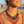 Charger l'image dans la galerie, Woman wearing a colorful beaded necklace with a blurred beach background
