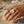 Load image into Gallery viewer, Hand wearing a silver ring with a textured band against a natural background
