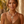 Load image into Gallery viewer, Woman wearing a decorative necklace with a blurred natural background
