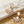 Charger l'image dans la galerie, Gold earrings with opal stones on a marble and sand background
