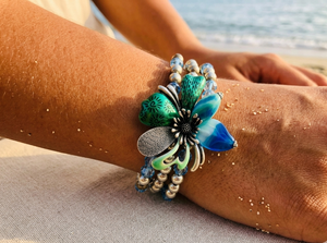 Decorative bracelet with floral design on a wrist by the beach