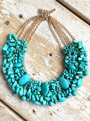 Turquoise stone necklace on a wooden surface