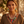 Load image into Gallery viewer, Woman wearing a colorful necklace and earrings with a blurred outdoor background
