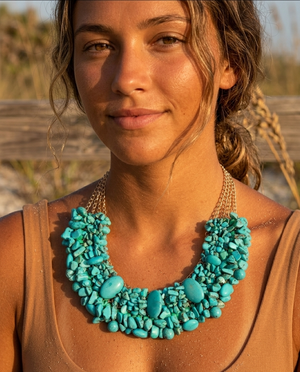 Woman wearing a turquoise necklace outdoors with a blurred natural background
