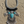 Load image into Gallery viewer, Decorative necklace with turquoise stones and silver accents on a sandy surface

