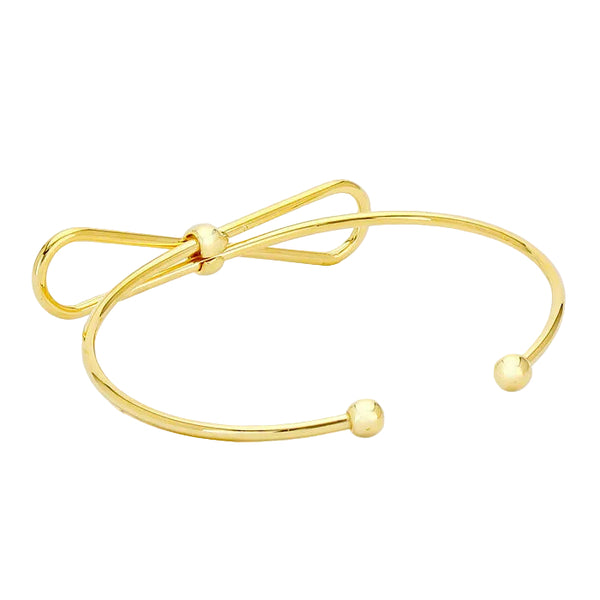 Gold bow-shaped bracelet on a light gray background