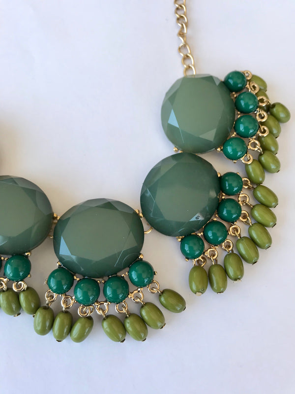 Green beaded necklace on a white background