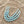 Load image into Gallery viewer, Turquoise beaded necklace with gold chain on a light pink background
