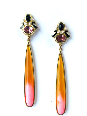 Pair of earrings with long teardrop-shaped stones on a white background