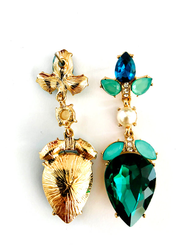 Pair of gold and gemstone earrings on a white background