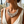 Charger l'image dans la galerie, Close-up of a woman wearing a sparkling necklace with a blurred floral background
