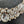 Charger l'image dans la galerie, Close-up of a decorative brooch with crystals on a dark background

