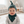 Load image into Gallery viewer, Baby wearing a green and black patterned hat and bib indoors.
