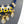 Charger l'image dans la galerie, A close-up of a statement bib necklace displayed on a dark gray mannequin bust. The necklace features a royal blue braided cord base with gold-tone metal accents, white rectangular inlays, black teardrop crystals, and dangling faceted clear glass beads with gold caps.
