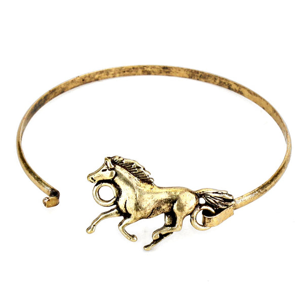 Gold horse-shaped bangle on a white background