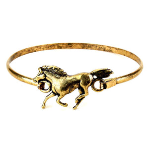 Gold bracelet with a horse design on a white background