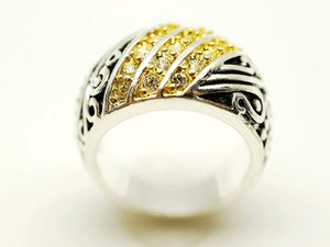 Silver ring with yellow gemstones on a white background