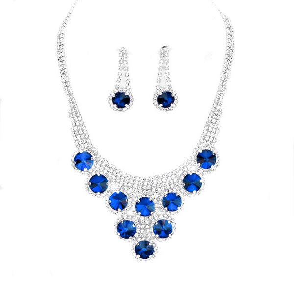 Jewelry set with blue gemstones on a white background