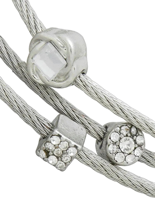 Close-up of silver beaded bracelet with clear stones on a light gray background