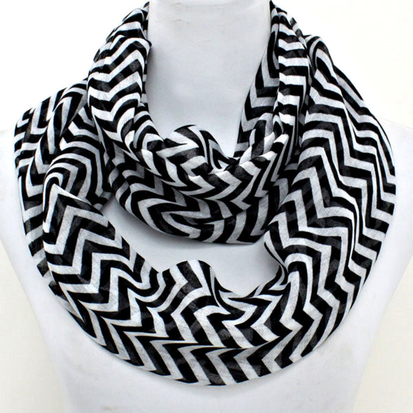 Black and white chevron patterned scarf on a mannequin with a white background