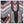 Charger l'image dans la galerie, A close-up of a patterned garment or textile featuring bold geometric and tribal-inspired motifs in black, white, pink, orange, blue, and brown.
