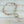 Load image into Gallery viewer, Necklace with pink and clear beads on a light gray background
