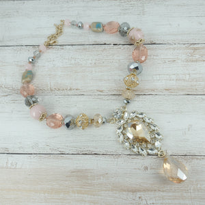 Necklace with pink and clear beads on a light gray background