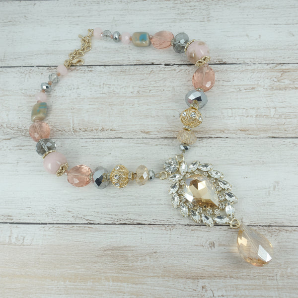 Necklace with pink and clear beads on a light gray background