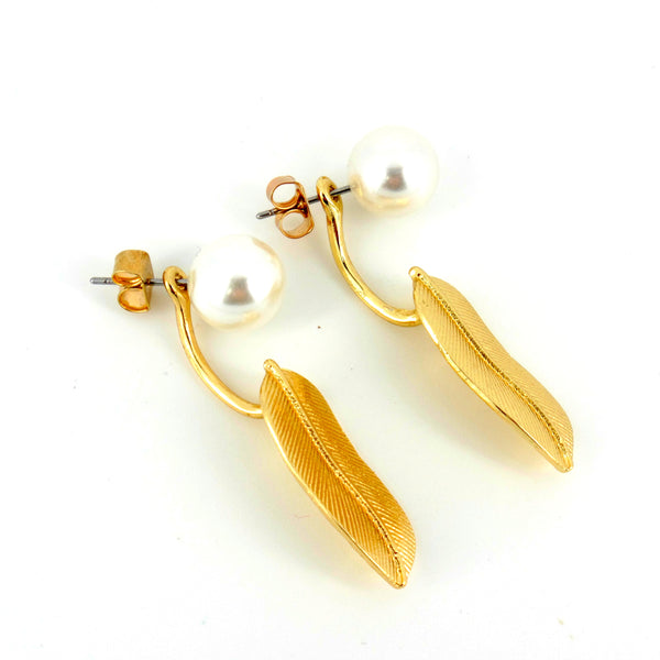 Gold feather earrings with pearls on a white background