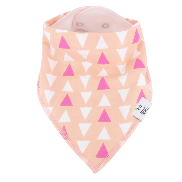 Baby bib with pink and white triangle pattern on a peach background
