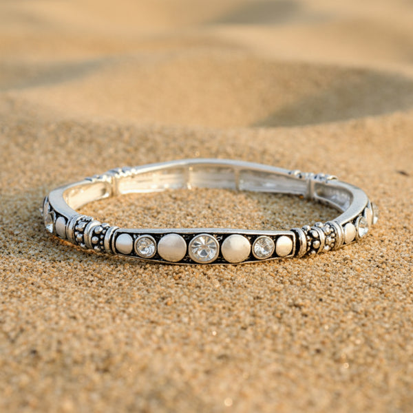 Silver bracelet with pearls and crystals on a white background