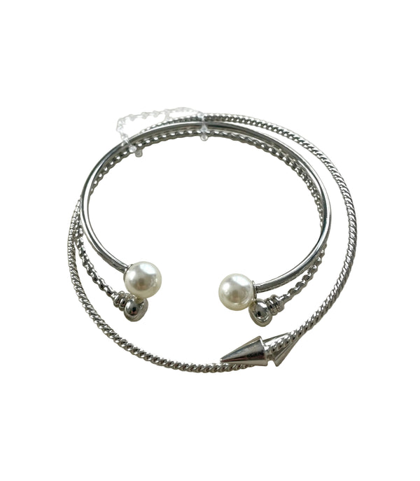 Silver bracelet with pearl beads on a light gray background