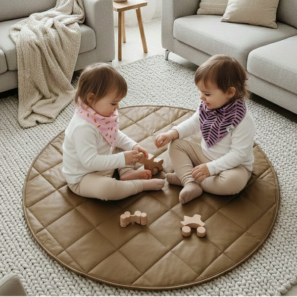 Two children playing on a round mat in a living room.