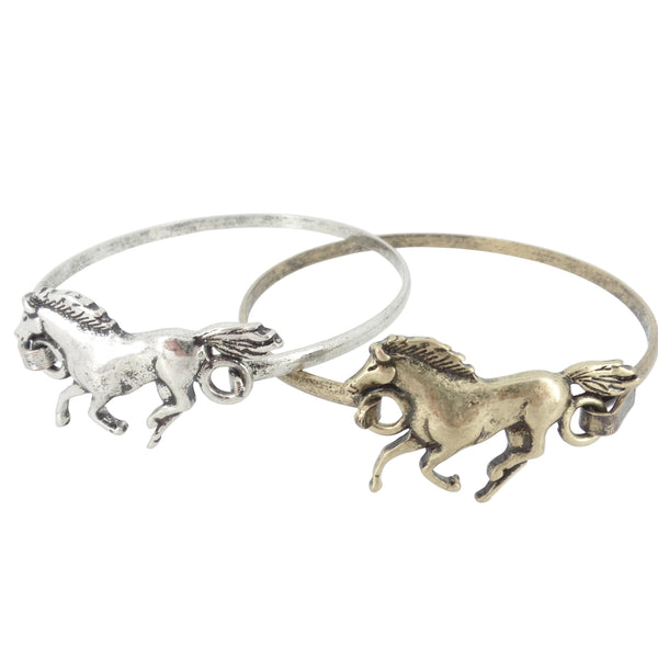 Two horse-shaped bracelets, one silver and one gold, on a white background.