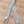 Load image into Gallery viewer, Light grey cashmere bunny scarf on pale wood floor
