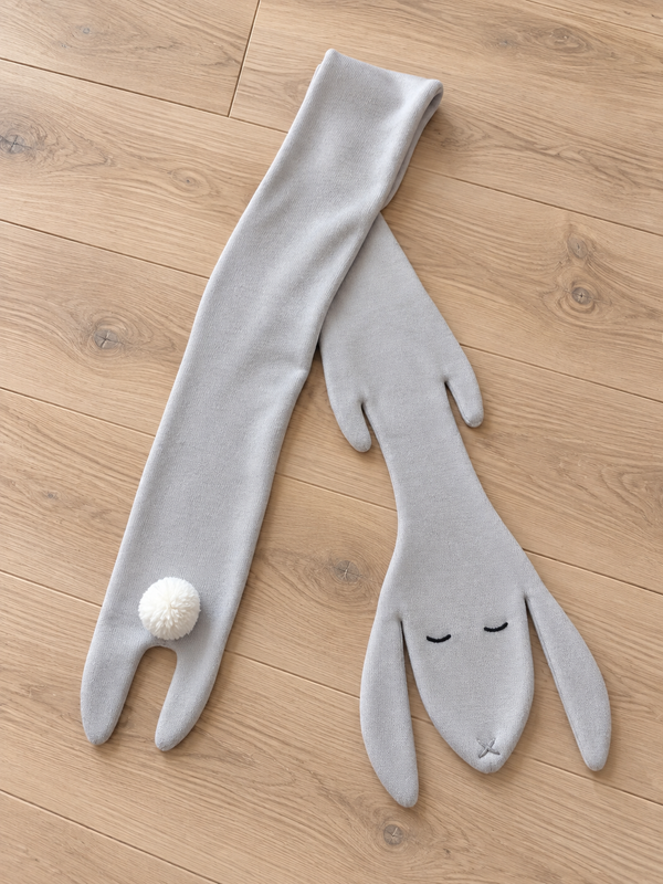 Light grey cashmere bunny scarf on pale wood floor