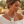 Load image into Gallery viewer, A woman wearing a chunky silver pendant necklace with a textured, organic-shaped centerpiece and matching silver hoop earrings, photographed outdoors with a warm, blurred background.
